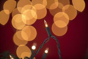 a string of lights is shown in front of a red background photo