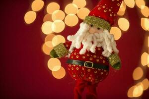 a santa claus doll with a beard and hat photo