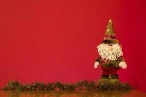 a santa claus doll with a beard and hat photo