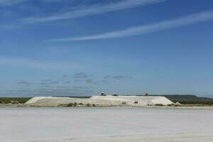 a large salt flat with a large building in the background photo