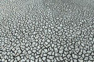 a close up of a cracked surface with some dirt photo