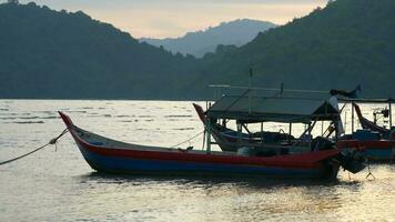 A couple of boats that are sitting in the water video