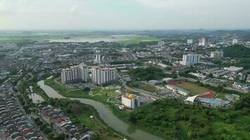 Cityscape with a meandering river cutting through its urban landscape at Bukit Mertajam video