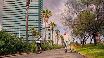 A cyclist riding along a city street with a towering building in the background video