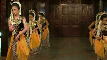 a group of Indonesian dancers with jasmine crowns dance together at a festival event video