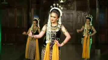 a group of Sundanese dancers with sitting movements while wearing gold colored costumes video