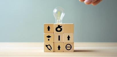 Creative idea, solution and innovation concept. Idea generation for business development. Wooden cube blocks with light bulb and cycle icons on clean background and copy space. photo