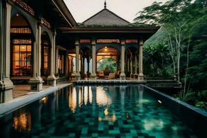 tailandés balinés lujo villa con infinito nadando piscina. un tropical jardín en ubud bali Indonesia concepto por ai generado foto