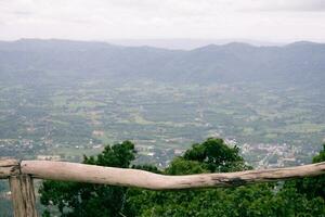 Wooden railings to see the sky and mountains with cold weather on the mountain photo