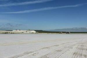 a large salt flat with a large building in the background photo