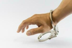 Man's hand in handcuffs, one side, white background photo