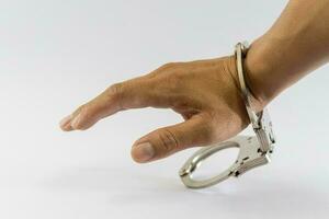 Man's hand in handcuffs, one side, white background photo
