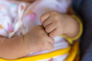 Hand of a baby girl, 1 month old, Thailand photo