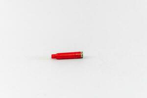 Bullet casing, red, isolated on white background photo