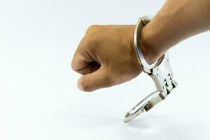 Man's hand in handcuffs, one side, white background photo