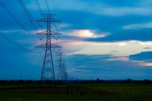 High-voltage pylons supply electricity to areas outside the city. beautiful sky photo