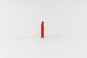 Bullet casing, red, isolated on white background photo