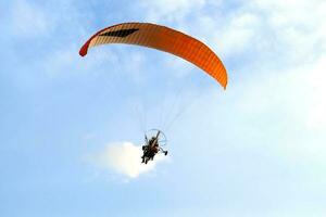 paraglider on blue sky photo
