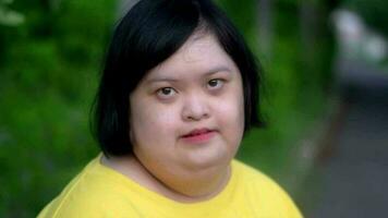 Asian young female  Down syndrome looking at you with smile. video