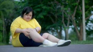 Asian girl with Down syndrome knee injury While exercising in the park. video