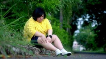 Asian girl with Down syndrome knee injury While exercising in the park. video