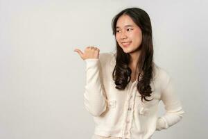 Portrait of attractive cheerful girl demonstrating and pointing finger to the side empty space isolated white background, showing advertisement, standing against. Advertisement presentation concept photo