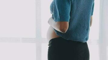 Close up of Asian mother woman showing stretch mark loose lower abdomen skin she fat after pregnancy baby birth, studio isolated on white background, Healthy belly overweight excess body concept video