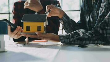 Construction and structure concept of engineer working drawing on blueprint meeting for project working with partner on model building and engineering tools in working site, construction concept. video