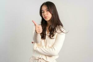 Portrait of attractive cheerful girl demonstrating and pointing finger to the side empty space isolated white background, showing advertisement, standing against. Advertisement presentation concept photo