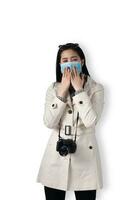 Young beautiful Asian women sling a camera and wearing a medical face mask on a white isolated background, Concept of travel tourism and vacation. photo