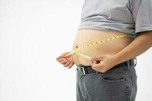 Overweight Man uses a measurement tape for measures his fat belly. isolated on white background. Concept of Healthcare, medicine, and  Weight loss photo