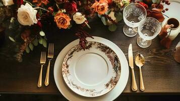 Autumn holiday tablescape, formal dinner table setting, table scape with elegant autumnal floral decor for wedding party and event decoration photo