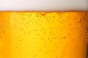 Close-up glass of cold beer with foam as texture and background, post-processed, photo
