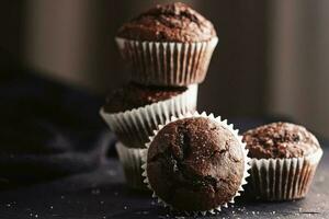 Homemade chocolate muffins, baked comfort food recipe photo