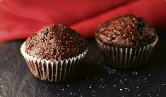 Two chocolate muffins freshly baked at home, homemade comfort food recipe photo