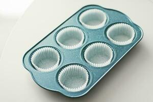 Chocolate muffin or cupcake batter in a pan ready to bake, homemade comfort food recipe photo