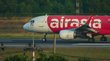 PHUKET, THAILAND NOVEMBER 26, 2019 - Airbus A320, 9M AQX of Asian Airlines arrives in Thailand. AirAsia low cost passenger aircraft taxiing at Phuket International Airport, Thailand HKT video