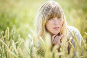 beautiful girl in a linen dress in a wheat field photo