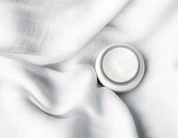 luxury face cream on soft silk - anti-aging, cosmetic and beauty styled concept photo