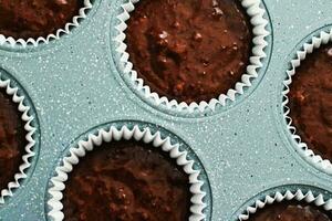 Chocolate muffin or cupcake batter in a pan ready to bake, homemade comfort food recipe photo