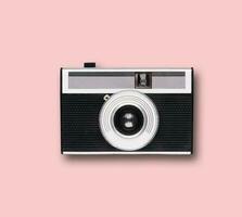 vintage old film camera on pink background photo