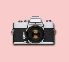 vintage old film camera on pink background photo