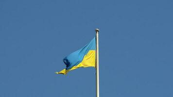 Ukrainian flag of Ukraine over blue sky photo