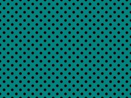 black polka dots over teal background photo