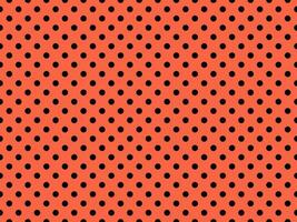 black polka dots over tomato background photo