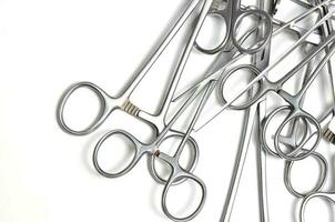 Surgical instruments on white background photo