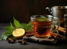 A cup of hot honey and sour green tea with spices on the wooden background photo