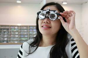 Lady wearing test glasses inside an ophthalmologist photo