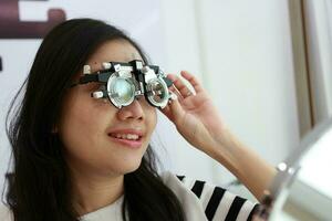 Thai lady wearing eyeglasses inside the clinic, woman in optical photo