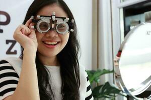 Thai lady wearing eyeglasses inside the clinic, woman in optical photo